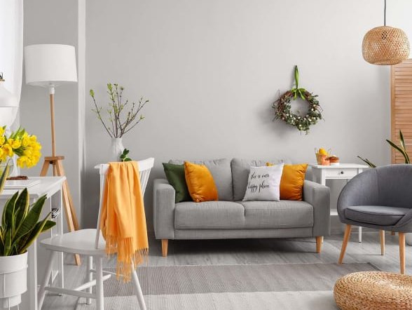 A room with a grey sofa and area rug